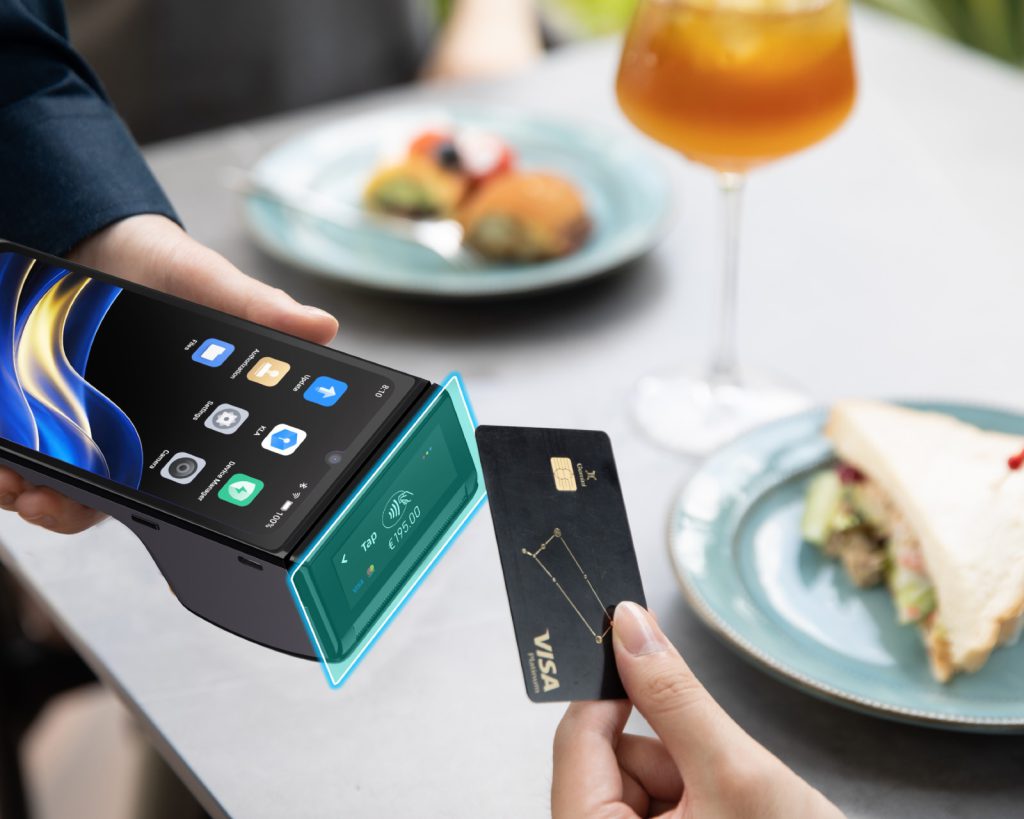 Customer tapping a card on an Android POS terminal at a café table
