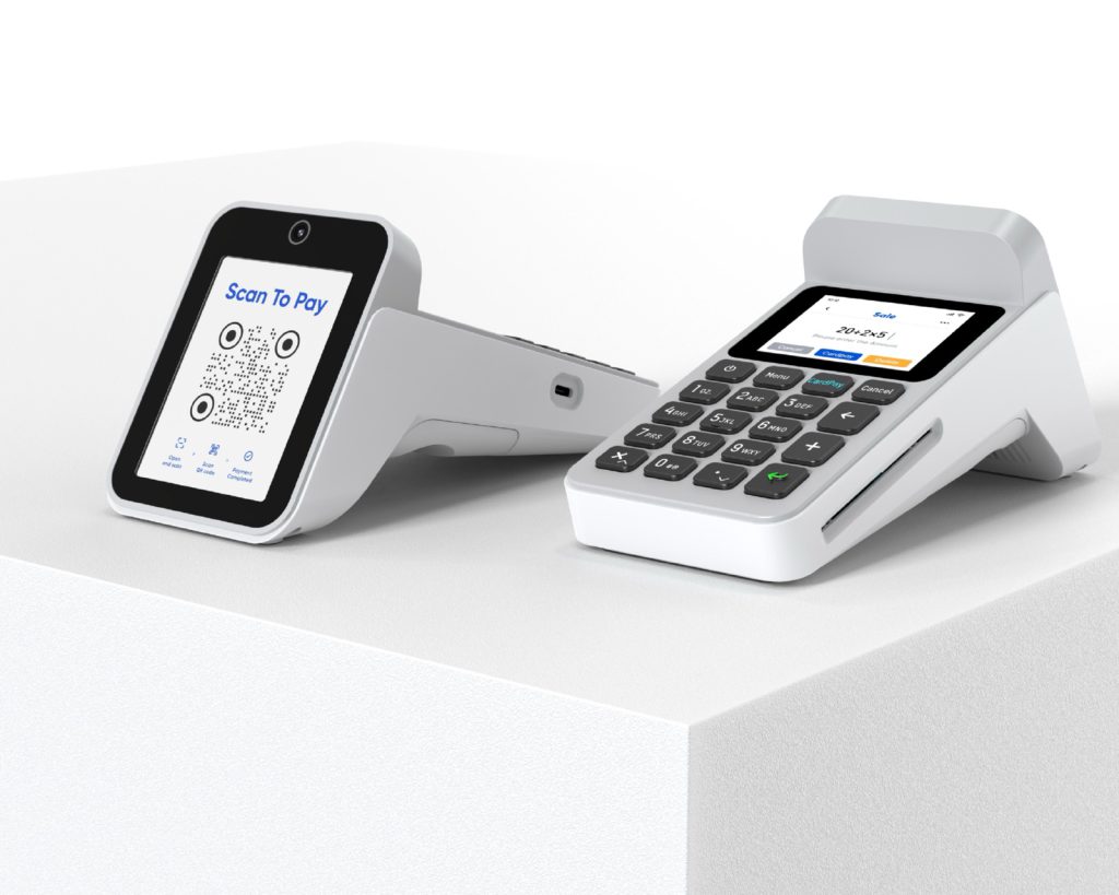 QR payment device beside a countertop payment terminal with keypad