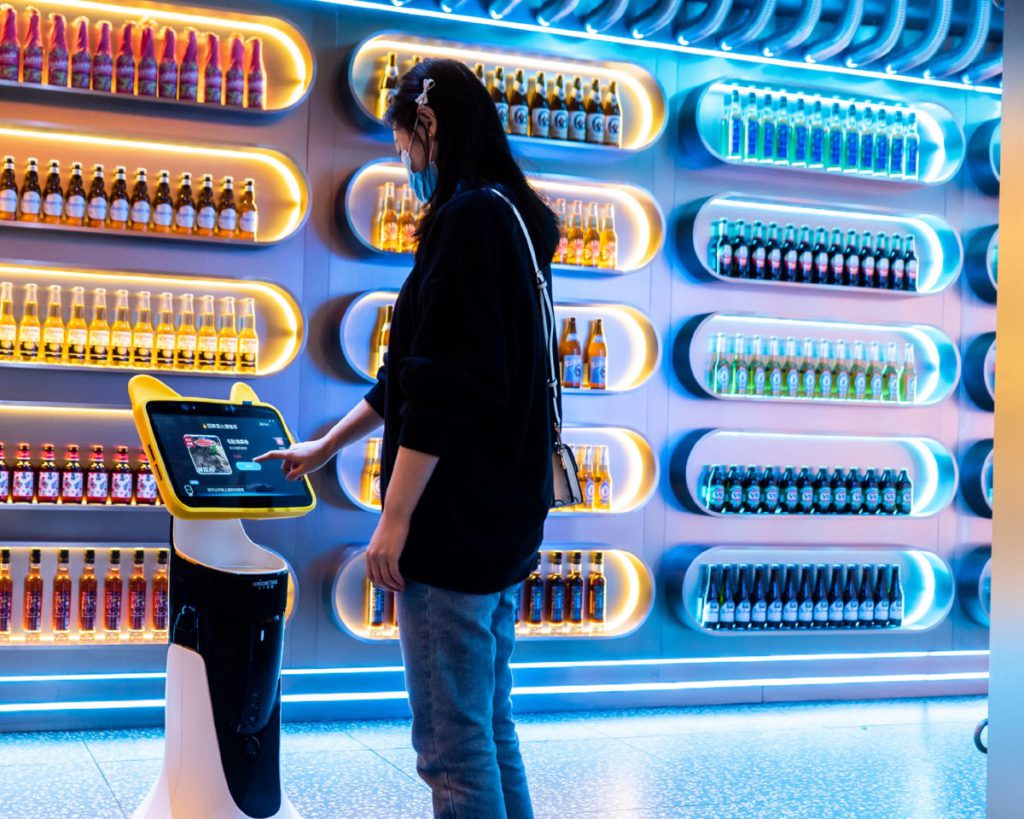 Customer using a service robot's touchscreen in a store